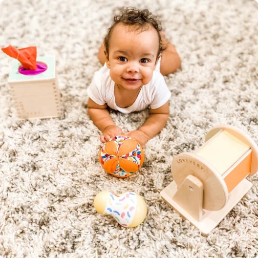 Baby doing tummy time with Lovevery toys from The Senser Play Kit