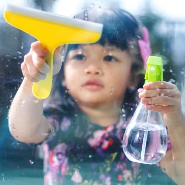 Child using the Squeaky Clean Squeegee Set from The Enthusiast Play Kit