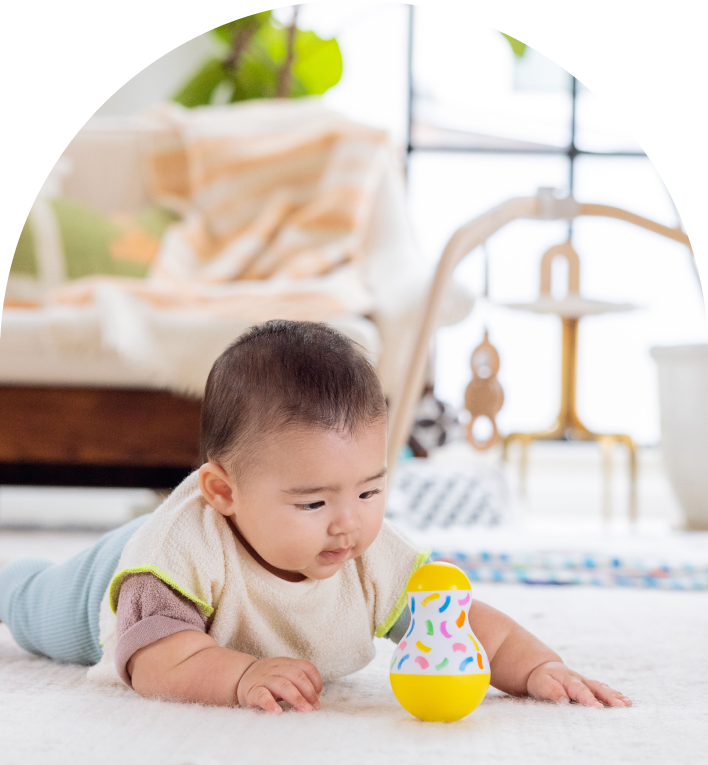 Child playing with the Tummy Time Wobbler from The Senser Play Kit