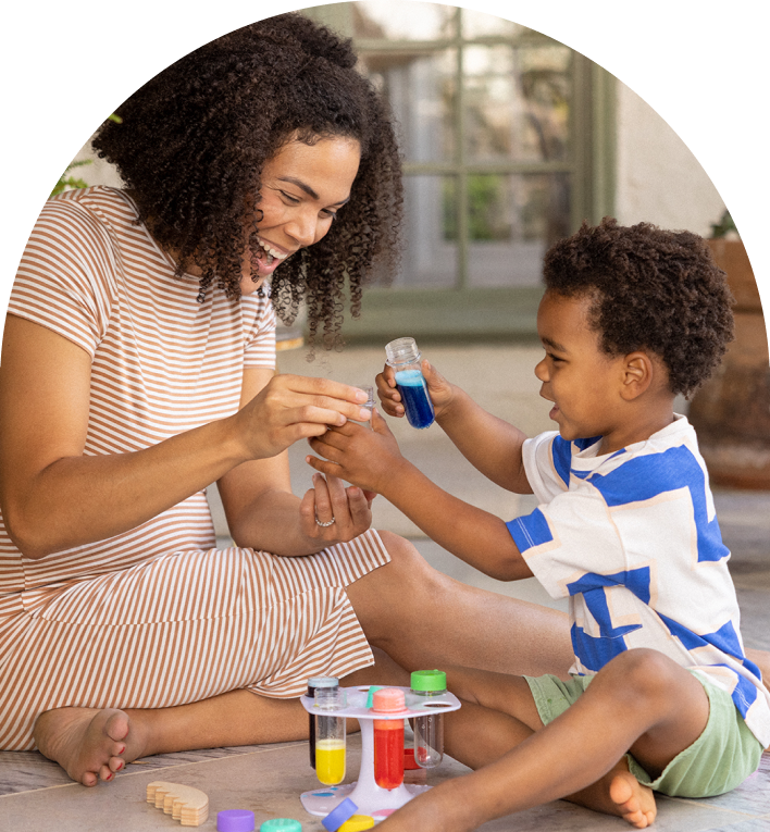 Mother and son playing with the Liquid Color Lab from The Problem Solver Play Kit