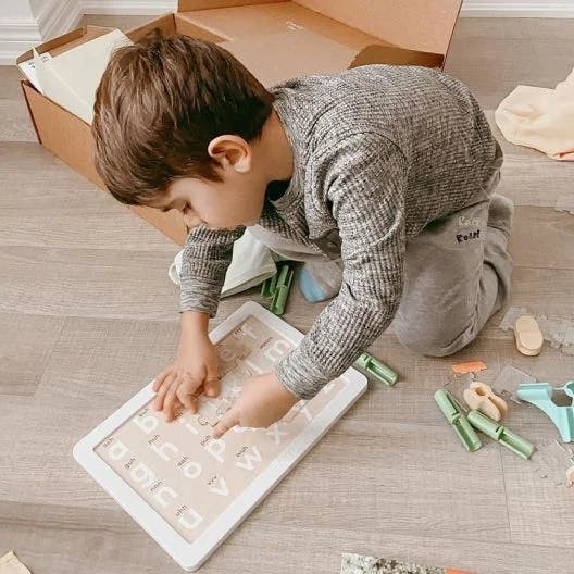 Boy doing the Letter Sounds Animal Puzzle from The Storyteller Play Kit