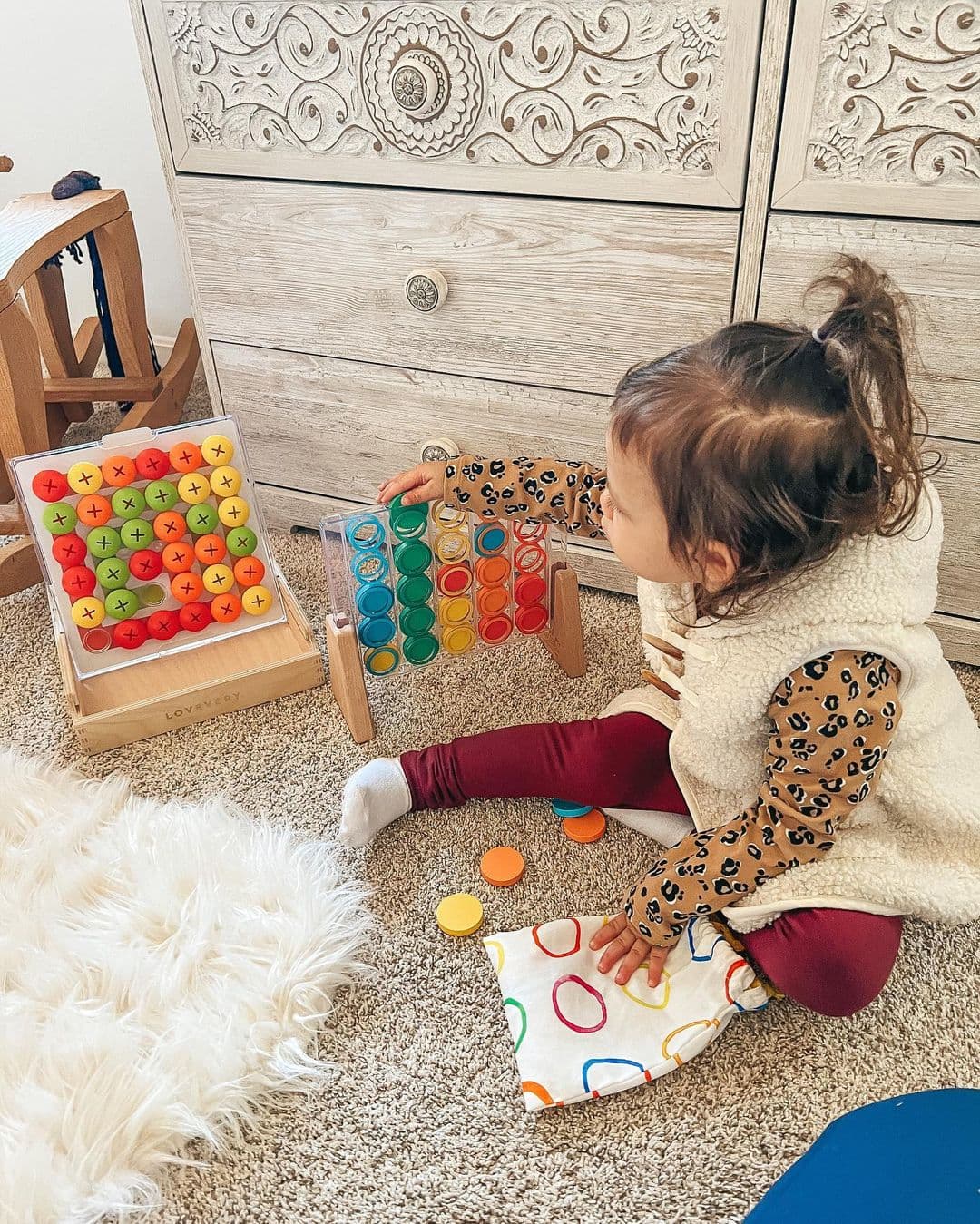 Toddler playing with various toys from Lovevery Play Kits