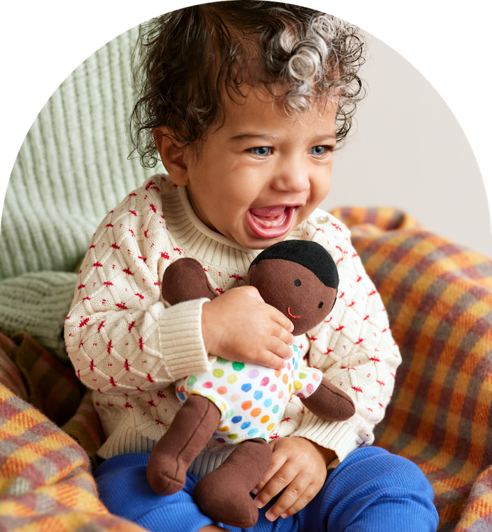 Child holding the Organic Cotton Baby Doll from Lovevery